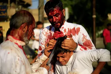 44EBB95600000578-0-Iraqi_Shi_ite_Muslims_gash_the_forehead_of_a_boy_with_a_sword_du-a-79_1506...webp