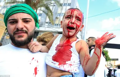 44ECADB700000578-0-A_Lebanese_Shi_ite_Muslim_man_holds_his_son_as_he_bleeds_after_h-a-69_1506...webp