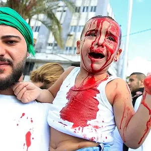 44ECADB700000578-0-A_Lebanese_Shi_ite_Muslim_man_holds_his_son_as_he_bleeds_after_h-a-69_1506...webp